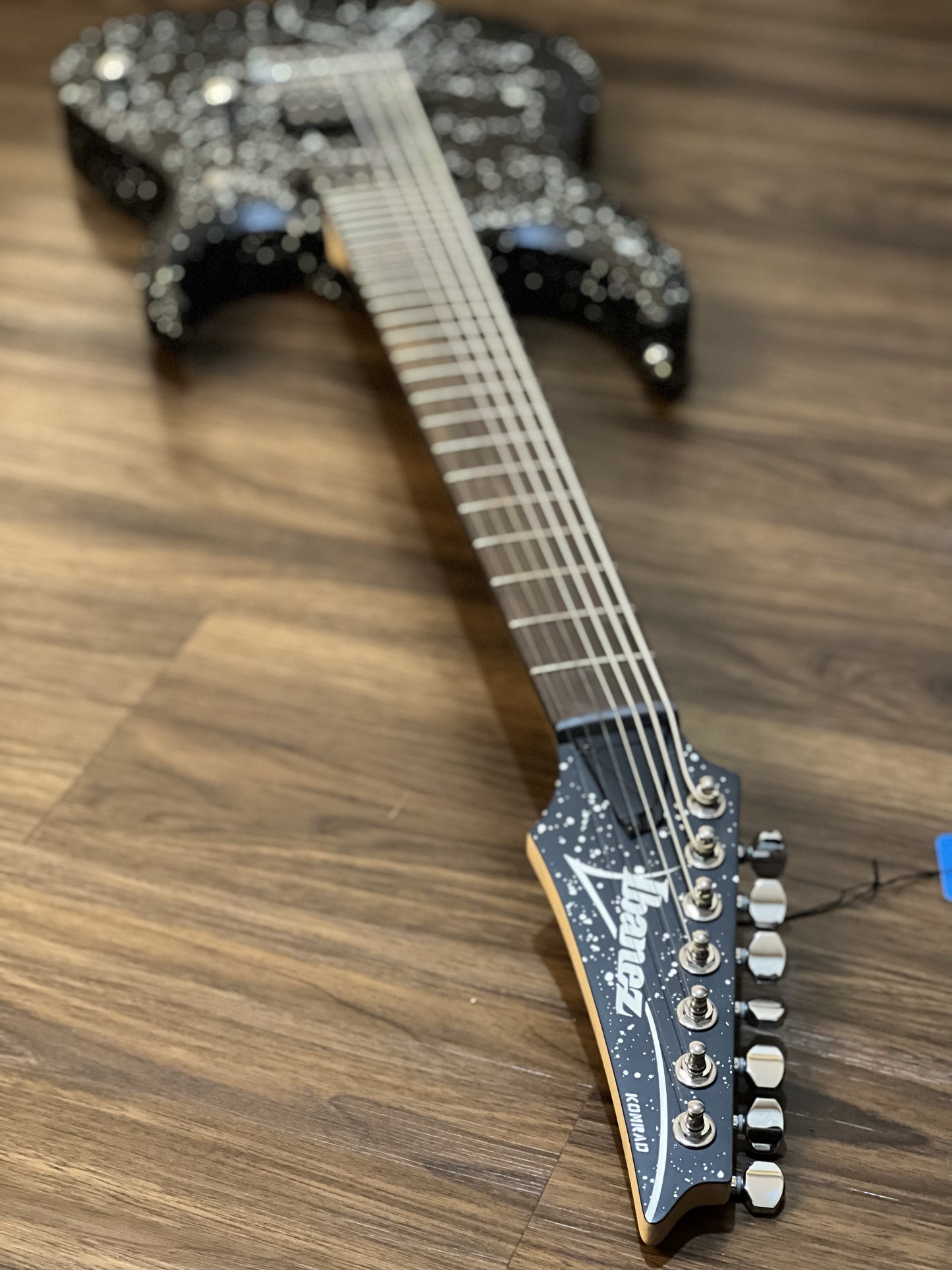 Ibanez KOMRAD20 Brian Head Signature 7-String in Black w/ White Splatter